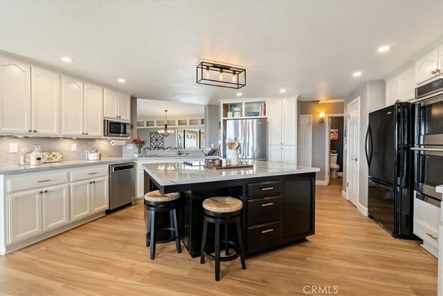 a kitchen with a sink cabinets and wooden floor