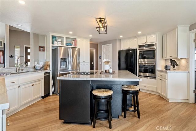 a kitchen with stainless steel appliances granite countertop a stove and a refrigerator