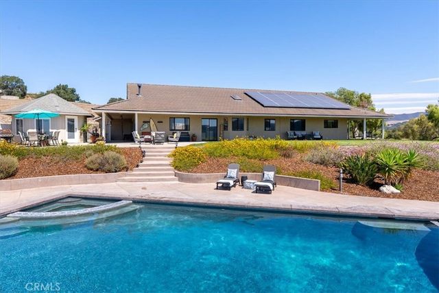 a view of house with outdoor seating and city view