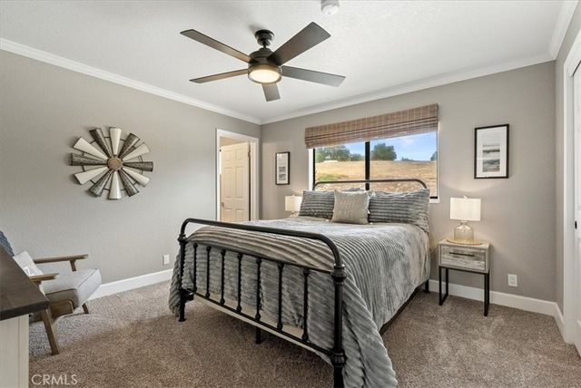 a bedroom with bed and a large window