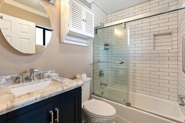 a bedroom with a bed couch and window