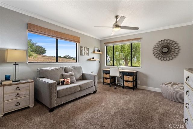 a view of a house with swimming pool and sitting area