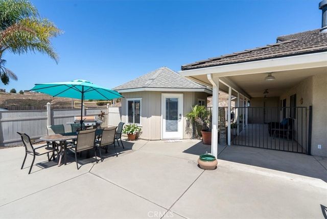 a view of a chairs and table in patio with a lake view