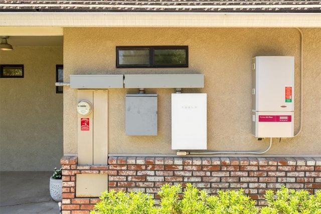 an aerial view of a house with a yard and lake view
