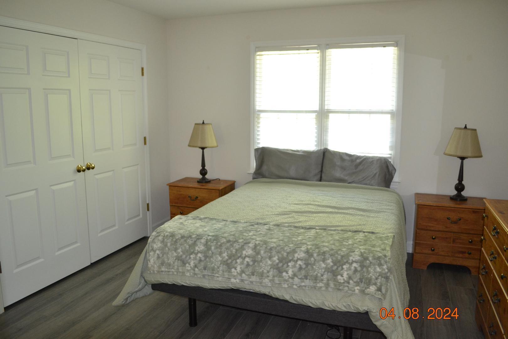 4506 Mistiflower Drive Raleigh, NC 27606 - Photo 25 of 27 a bedroom with a bed and a window