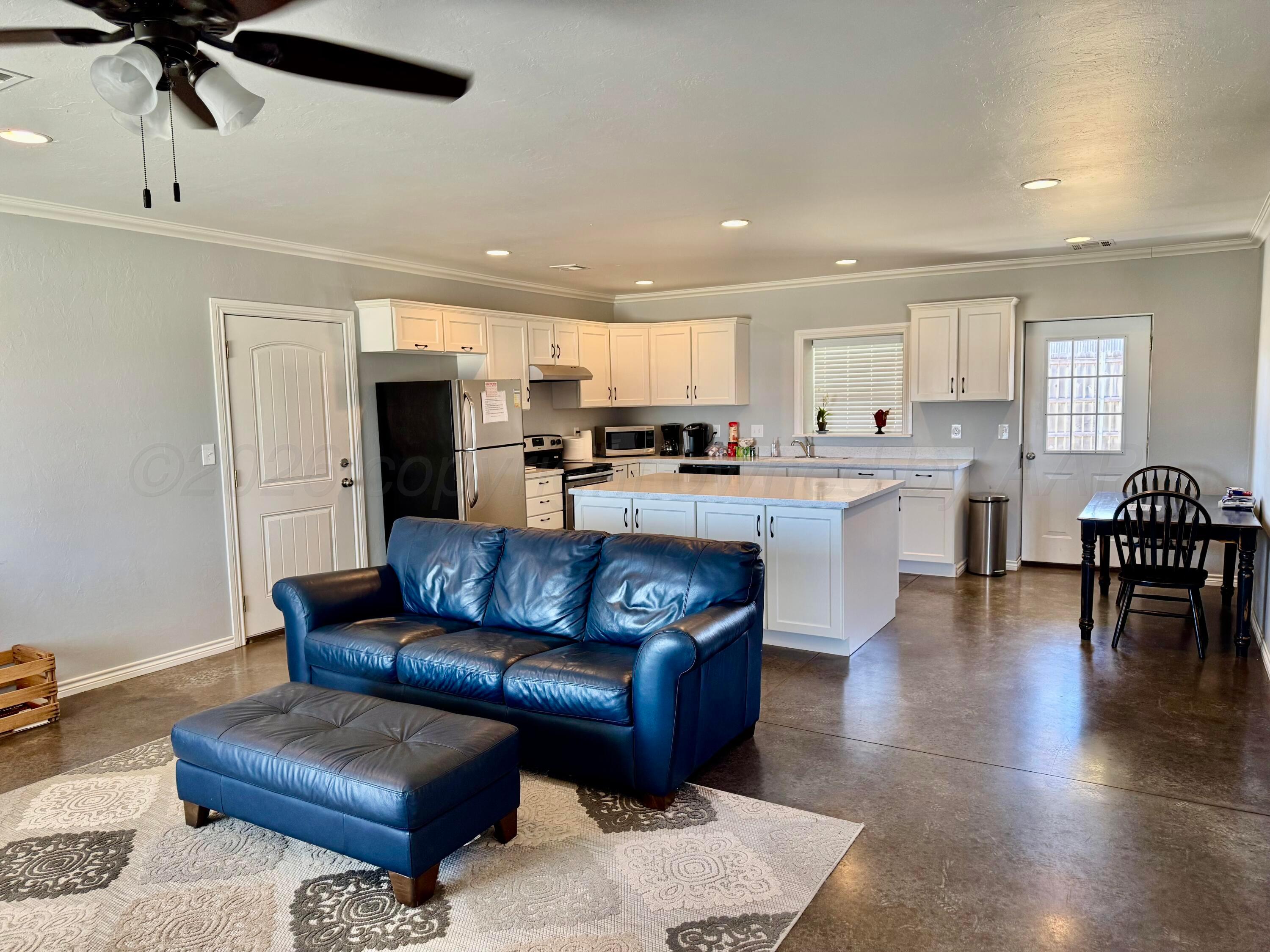 613 North 8th Street Canadian, TX 79014 - Photo 2 of 6 a living room with stainless steel appliances kitchen island granite countertop furniture and a view of kitchen