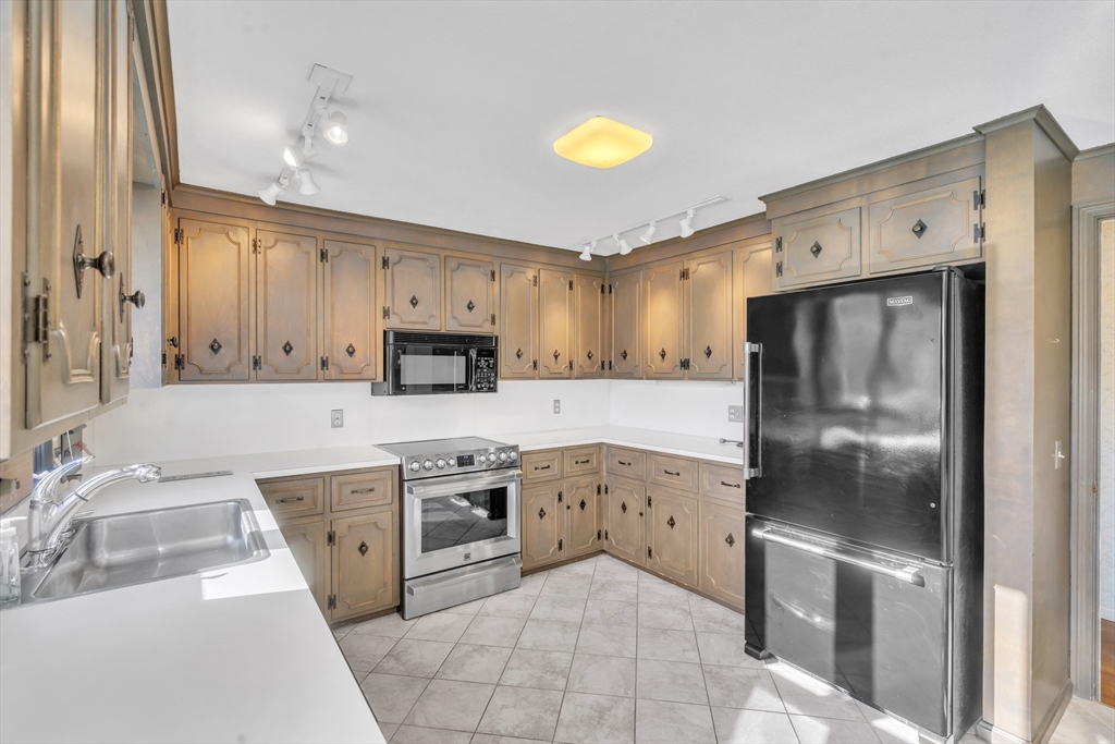 50 Old Wilson Road Northampton, MA 01062 - Photo 10 of 42 a kitchen with stainless steel appliances granite countertop a refrigerator a stove and a sink with wooden floor