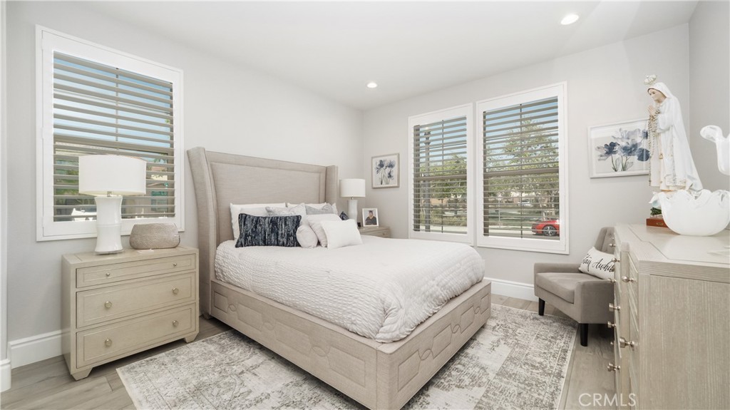 4699 Reflection Lane Ontario, CA 91762 - Photo 11 of 32 a bedroom with a large bed and a table