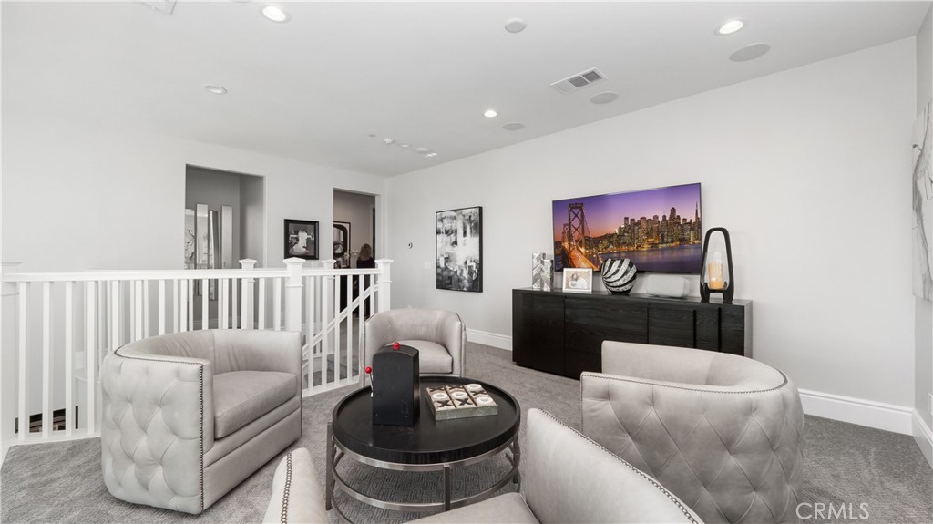 4699 Reflection Lane Ontario, CA 91762 - Photo 13 of 32 a living room with furniture and a wooden floor