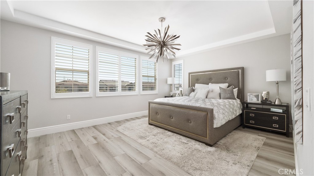 4699 Reflection Lane Ontario, CA 91762 - Photo 14 of 32 a bedroom with a large bed and a tv on a dresser