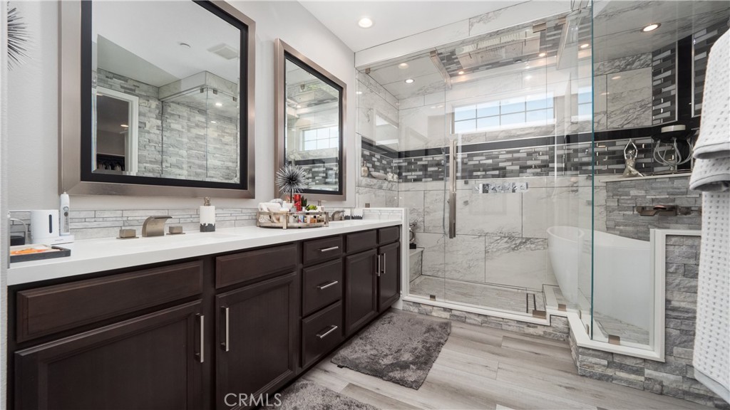 4699 Reflection Lane Ontario, CA 91762 - Photo 15 of 32 a bathroom with a double vanity sink a toilet a mirror and shower