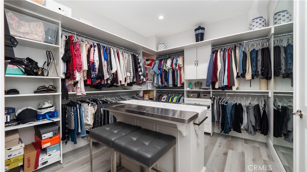 4699 Reflection Lane Ontario, CA 91762 - Photo 17 of 32 a view of walk in closet with clothes and shoes