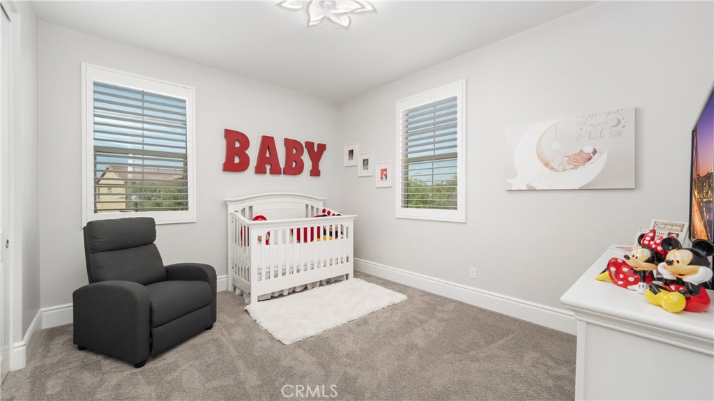 4699 Reflection Lane Ontario, CA 91762 - Photo 20 of 32 a bedroom with a bed and a couch