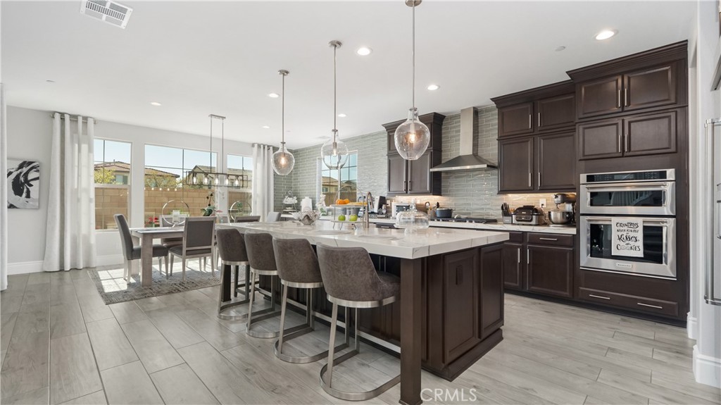 4699 Reflection Lane Ontario, CA 91762 - Photo 2 of 32 a kitchen with a sink dining table and chairs