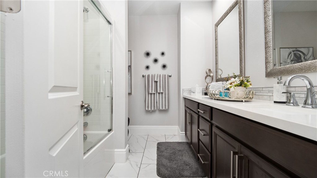 4699 Reflection Lane Ontario, CA 91762 - Photo 21 of 32 a spacious bathroom with a double vanity sink a mirror and a shower