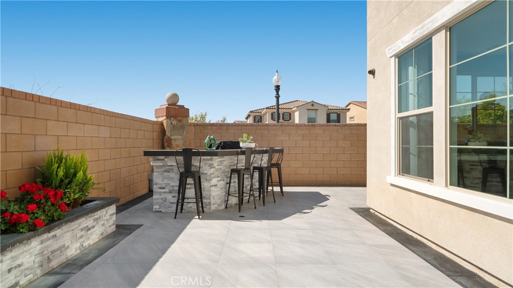 4699 Reflection Lane Ontario, CA 91762 - Photo 23 of 32 a view of a patio with table and chairs and potted plants