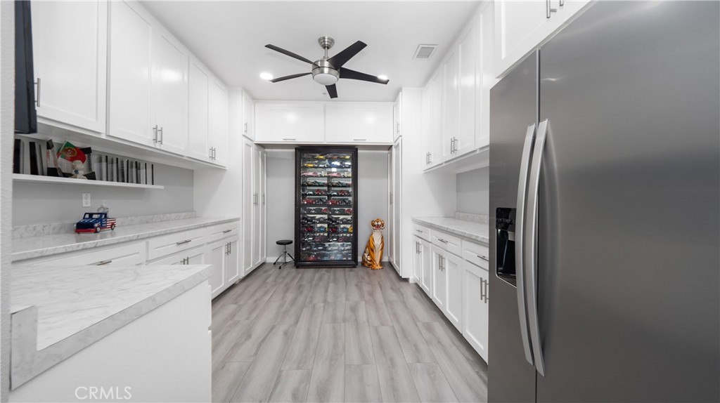 4699 Reflection Lane Ontario, CA 91762 - Photo 26 of 32 a kitchen with granite countertop a refrigerator and a stove top oven