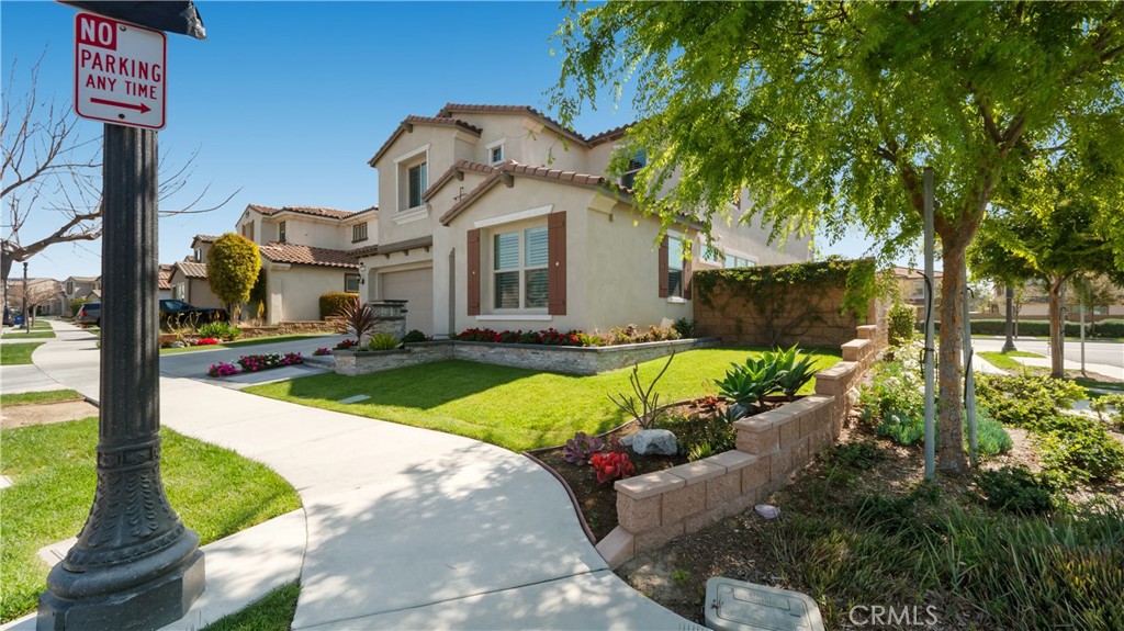 4699 Reflection Lane Ontario, CA 91762 - Photo 28 of 32 a front view of a house with garden