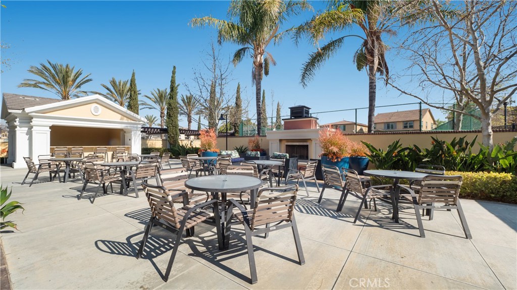 4699 Reflection Lane Ontario, CA 91762 - Photo 30 of 32 a view of a patio with a table and chairs and a barbeque