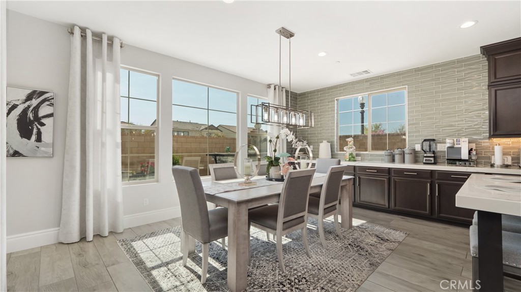 4699 Reflection Lane Ontario, CA 91762 - Photo 5 of 32 a kitchen with a table chairs and microwave