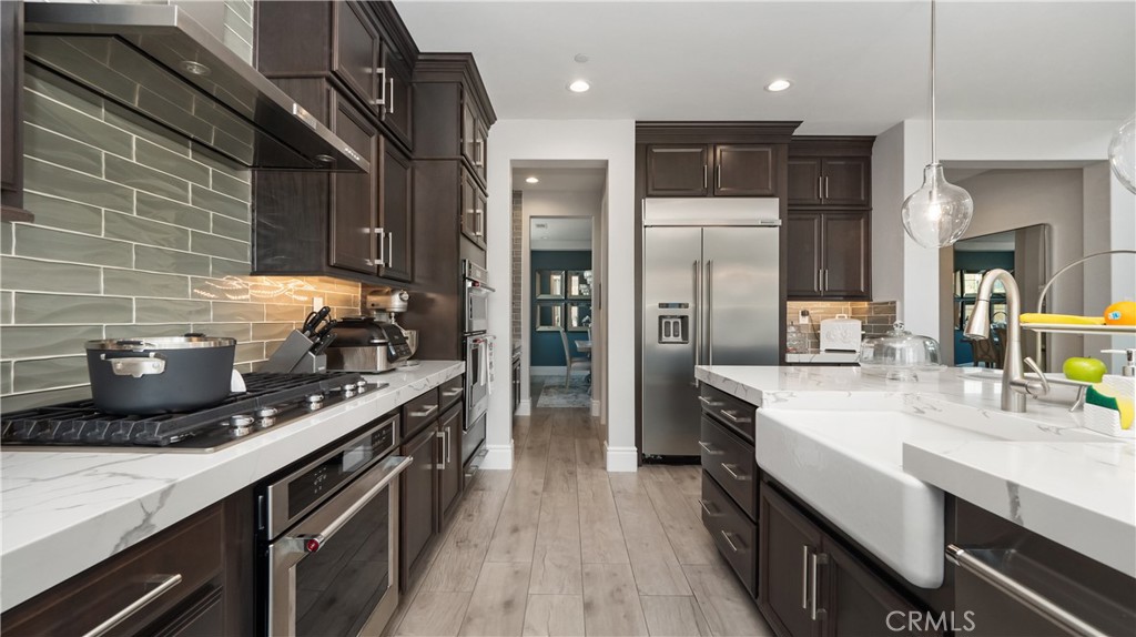 4699 Reflection Lane Ontario, CA 91762 - Photo 6 of 32 a kitchen with stainless steel appliances a sink stove and refrigerator