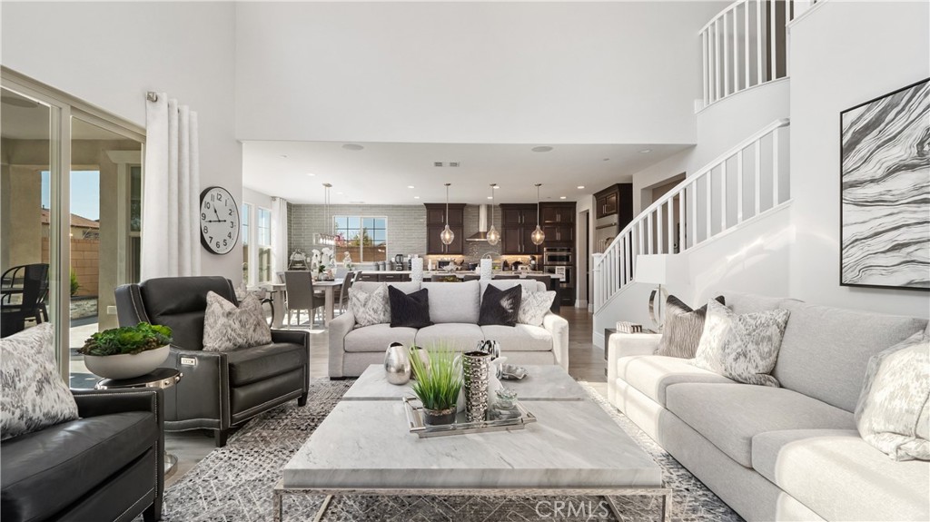 4699 Reflection Lane Ontario, CA 91762 - Photo 9 of 32 a living room with furniture or couch and a dining table