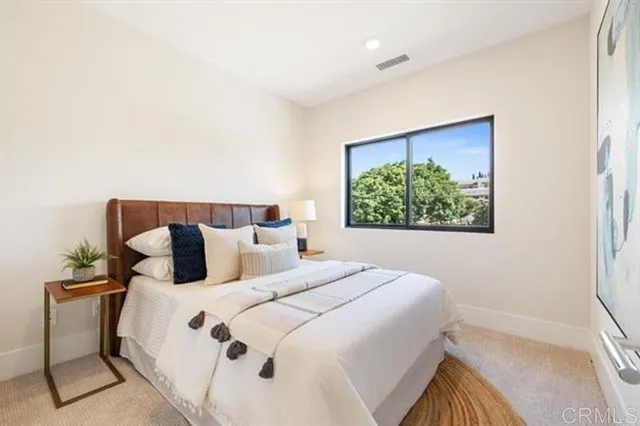 a bedroom with a large bed and a window