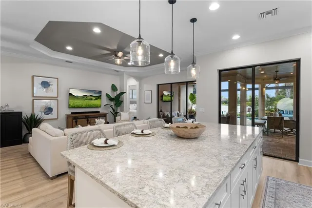 a view of a dining room with furniture a chandelier and wooden floor
