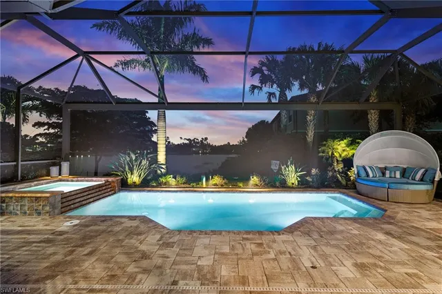 a backyard of a house with barbeque oven table and chairs