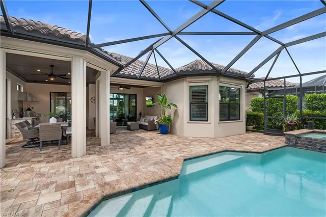 a front view of multi story residential apartment building with yard and green space