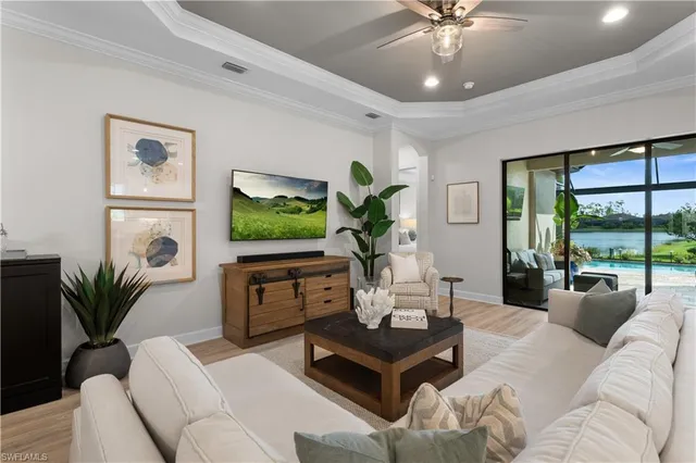 a living room with furniture a window and a flat screen tv
