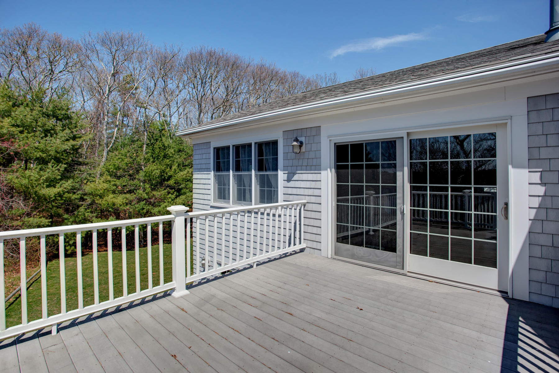 160 Bay Road Cotuit, MA 02635 - Photo 27 of 31 a view of backyard with large windows and wooden floor
