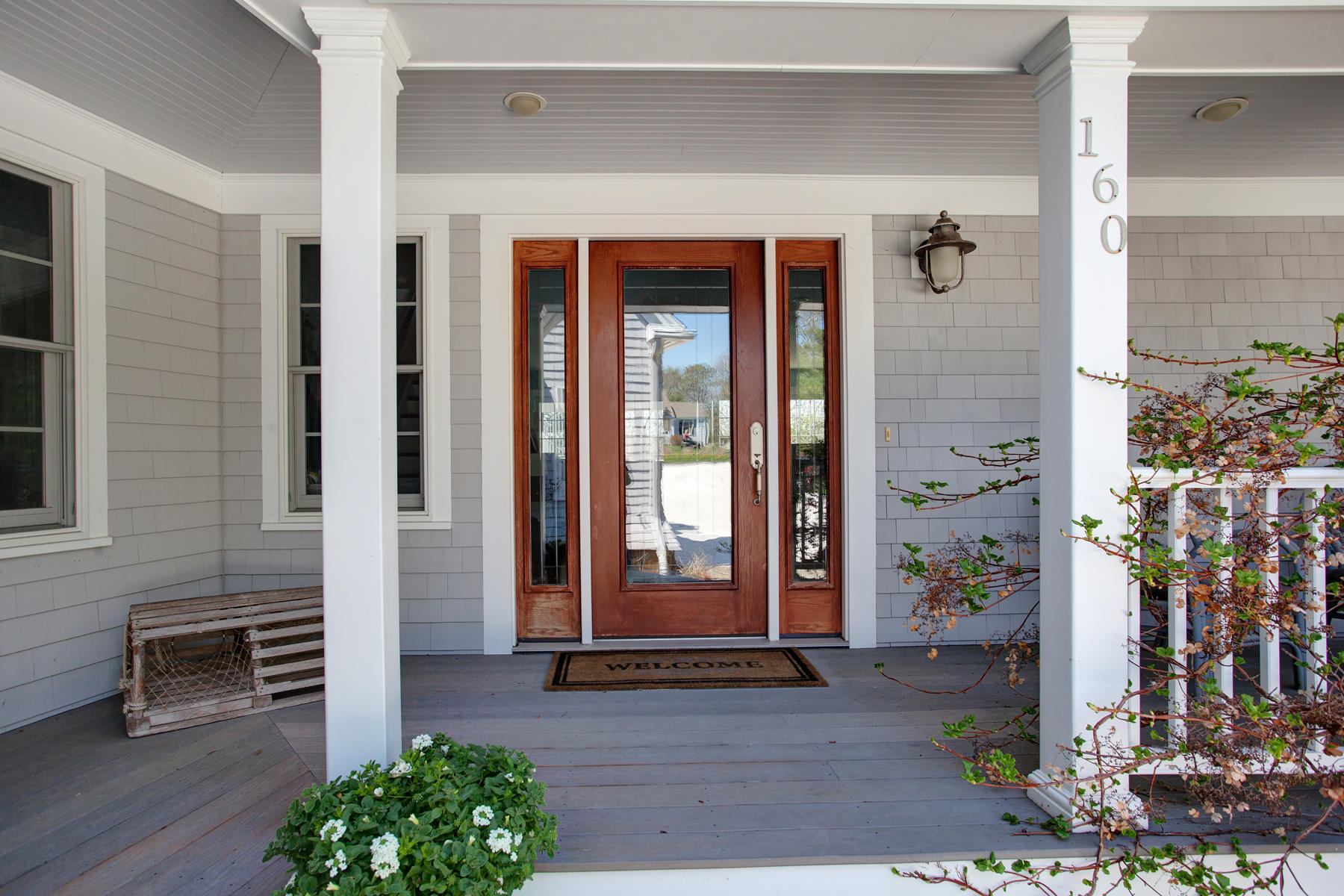 160 Bay Road Cotuit, MA 02635 - Photo 6 of 31 a front view of a house with a garden
