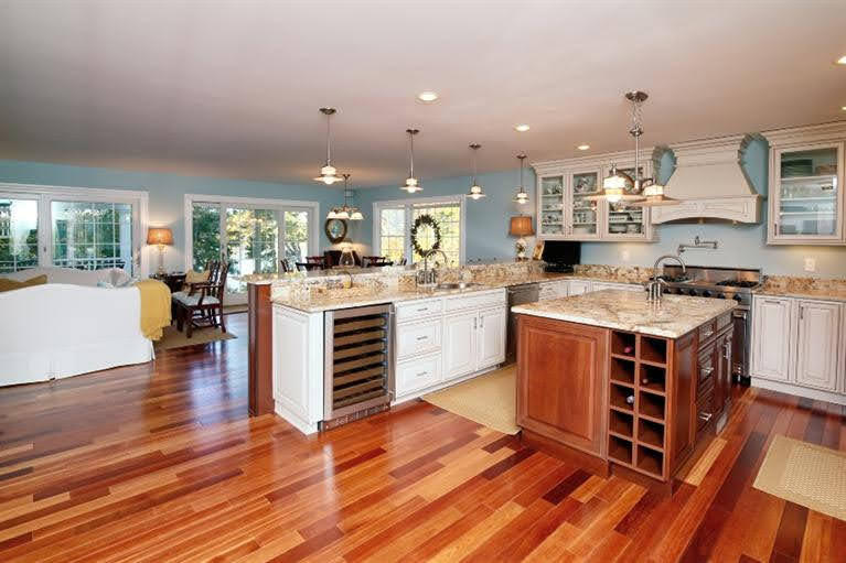 160 Bay Road Cotuit, MA 02635 - Photo 7 of 31 a kitchen with stainless steel appliances a stove top oven and cabinets