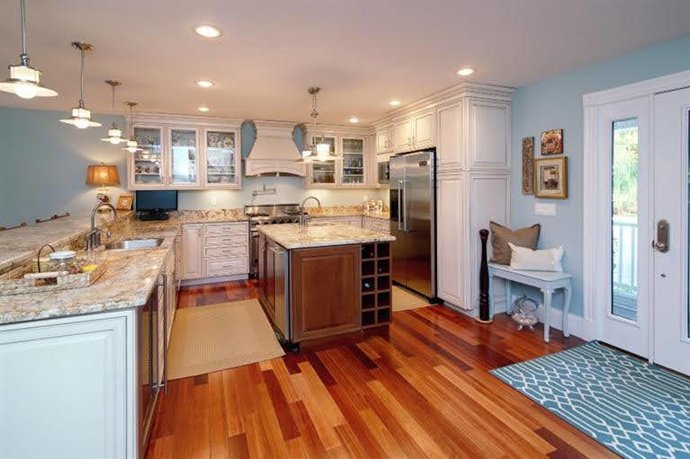 160 Bay Road Cotuit, MA 02635 - Photo 9 of 31 a kitchen with stainless steel appliances granite countertop a sink stove and refrigerator