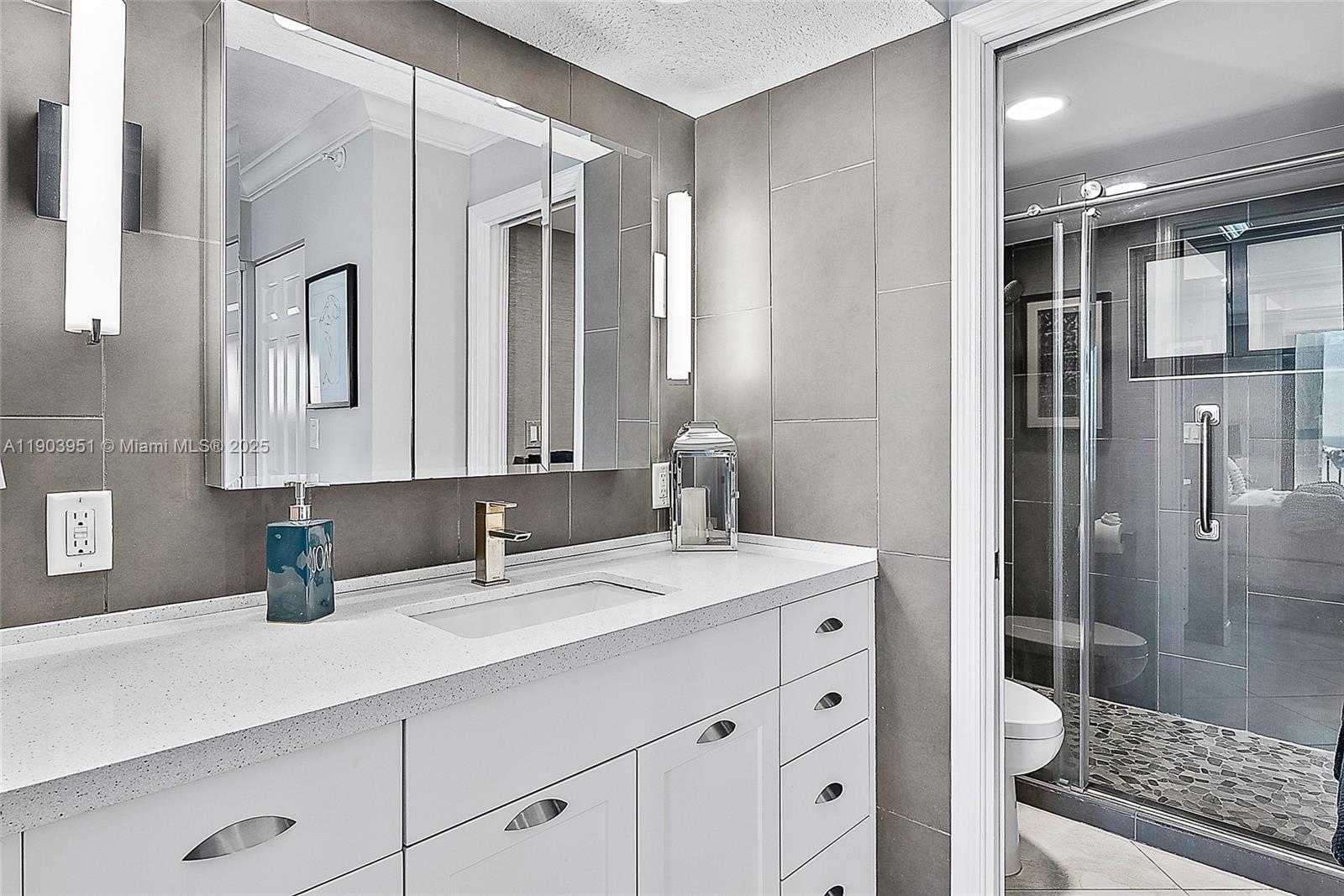 400 Ocean Trail Way, Unit 1005 Jupiter, FL 33477 - Photo 12 of 23 a bathroom with a double vanity sink mirror and shower