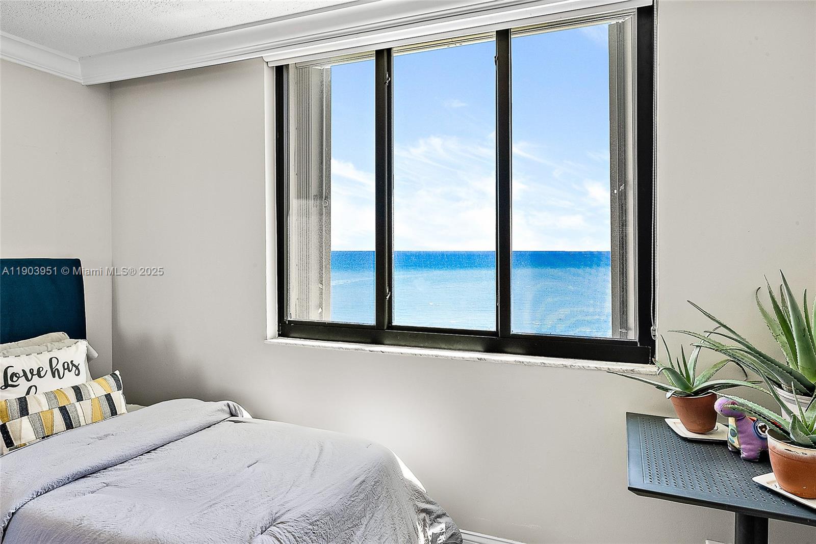 400 Ocean Trail Way, Unit 1005 Jupiter, FL 33477 - Photo 13 of 23 a bedroom with a bed and a window