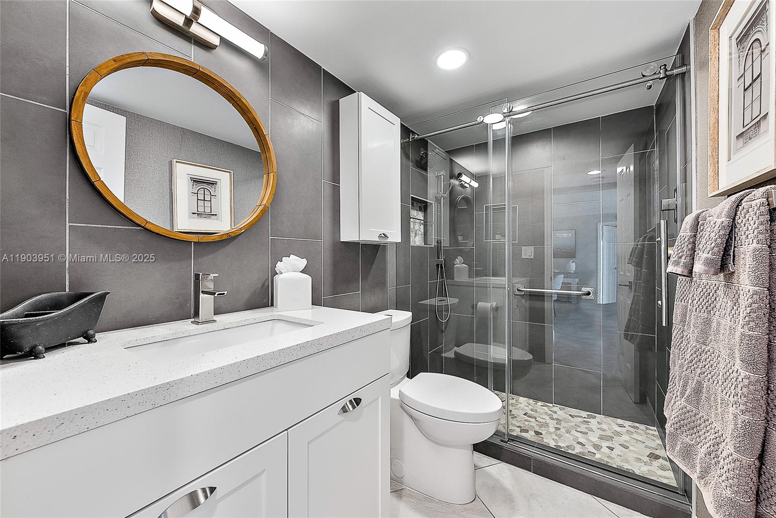 400 Ocean Trail Way, Unit 1005 Jupiter, FL 33477 - Photo 15 of 23 a bathroom with a sink a toilet and a mirror