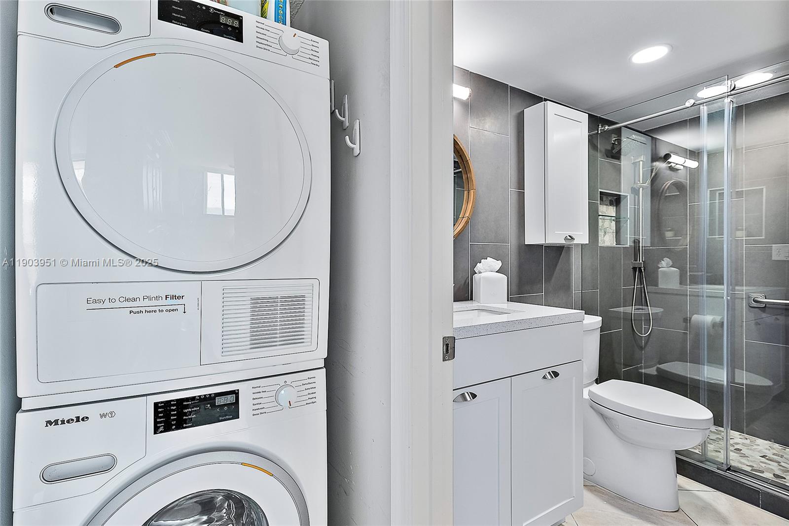 400 Ocean Trail Way, Unit 1005 Jupiter, FL 33477 - Photo 16 of 23 a bathroom with a sink a toilet and a mirror