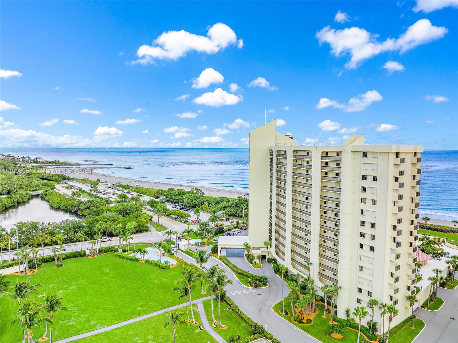 400 Ocean Trail Way, Unit 1005 Jupiter, FL 33477 - Photo 3 of 23 a view of a multi story residential apartment building with a yard
