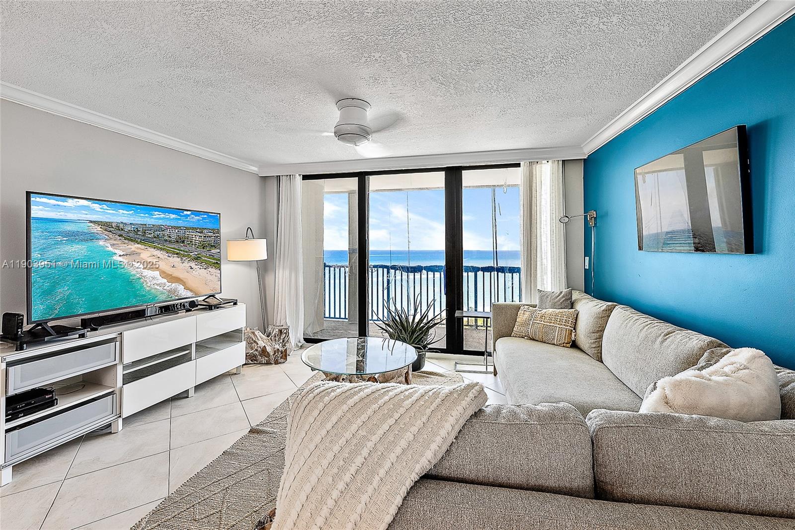 400 Ocean Trail Way, Unit 1005 Jupiter, FL 33477 - Photo 5 of 23 a living room with furniture and a flat screen tv