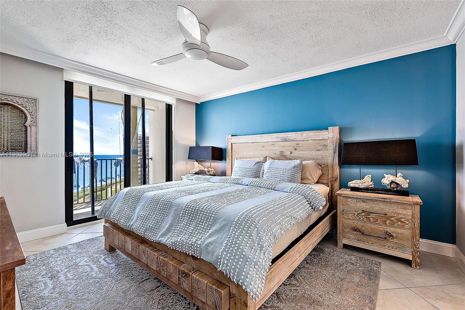 400 Ocean Trail Way, Unit 1005 Jupiter, FL 33477 - Photo 10 of 23 a bedroom with a bed a ceiling fan and a dresser