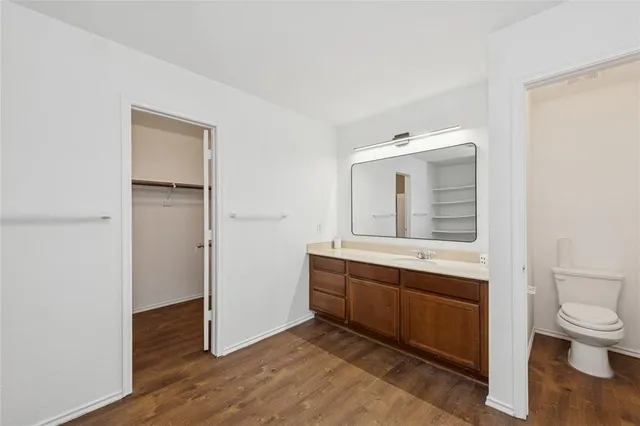 a view of bathroom with a toilet a sink and a mirror