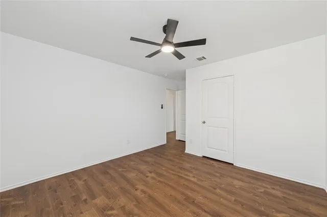 a view of a room with wooden floor