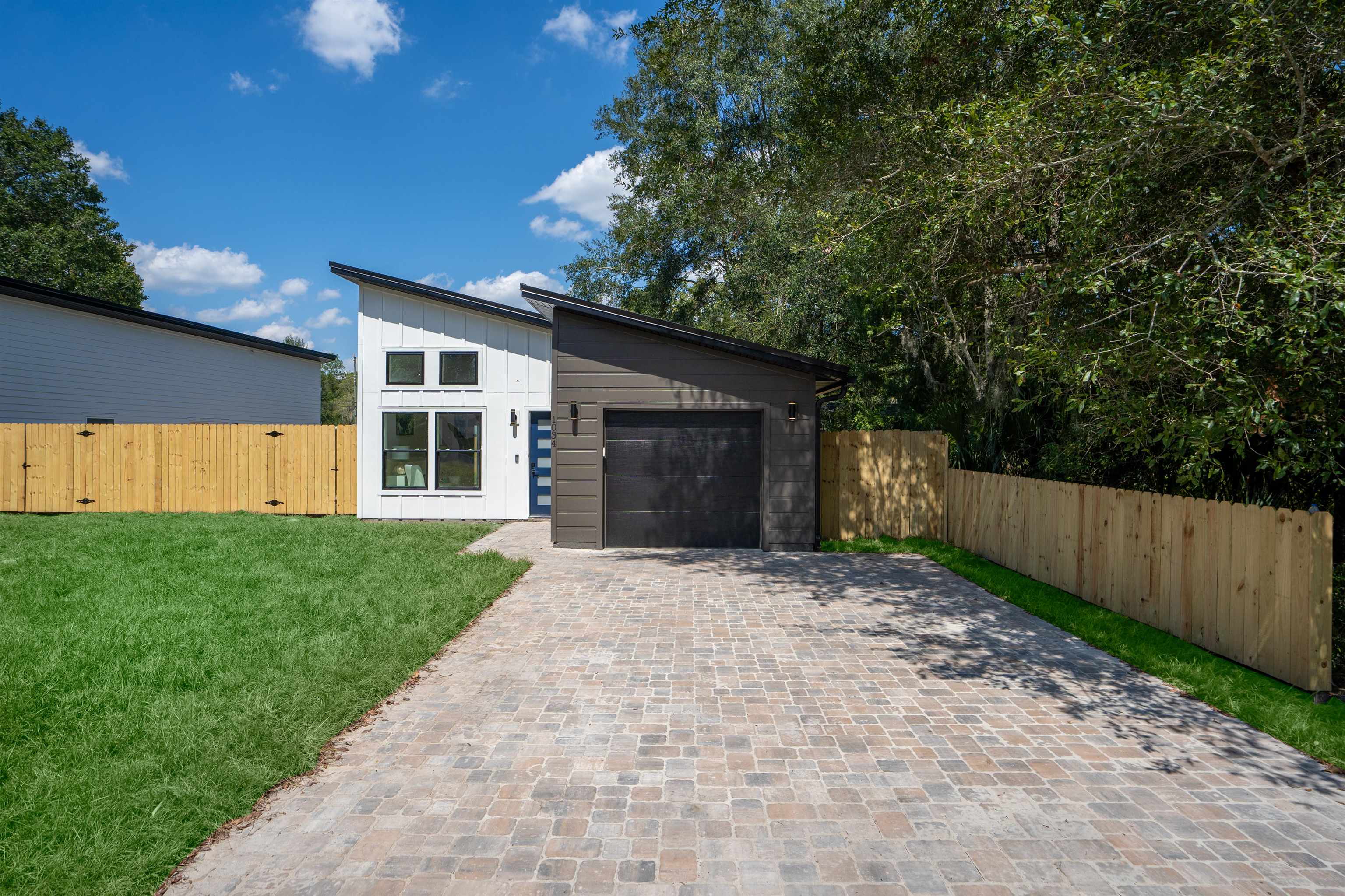 816 West 9th Street St. Augustine, FL 32084 - Photo 27 of 28 a front view of a house with a yard and garage