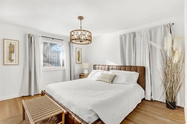 a bedroom with a bed and a chandelier