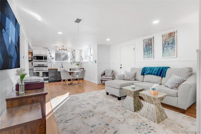 a living room with furniture and kitchen view