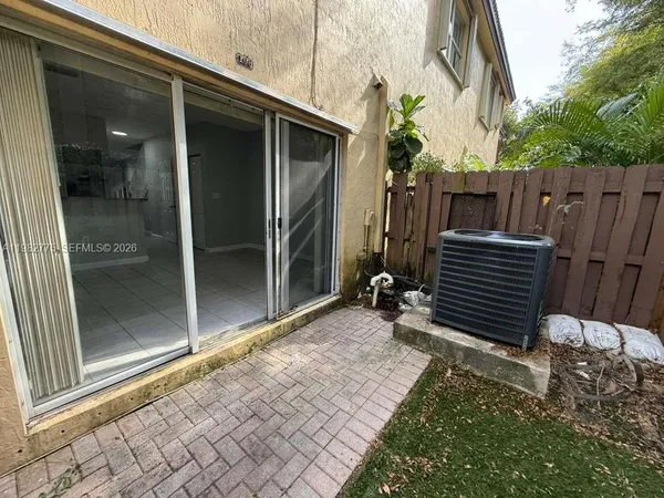 a view of backyard with wooden fence