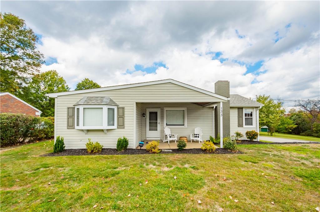 133 Baker Rd Extension Monaca, PA 15061 - Photo 1 of 25 a front view of house with yard and trees around