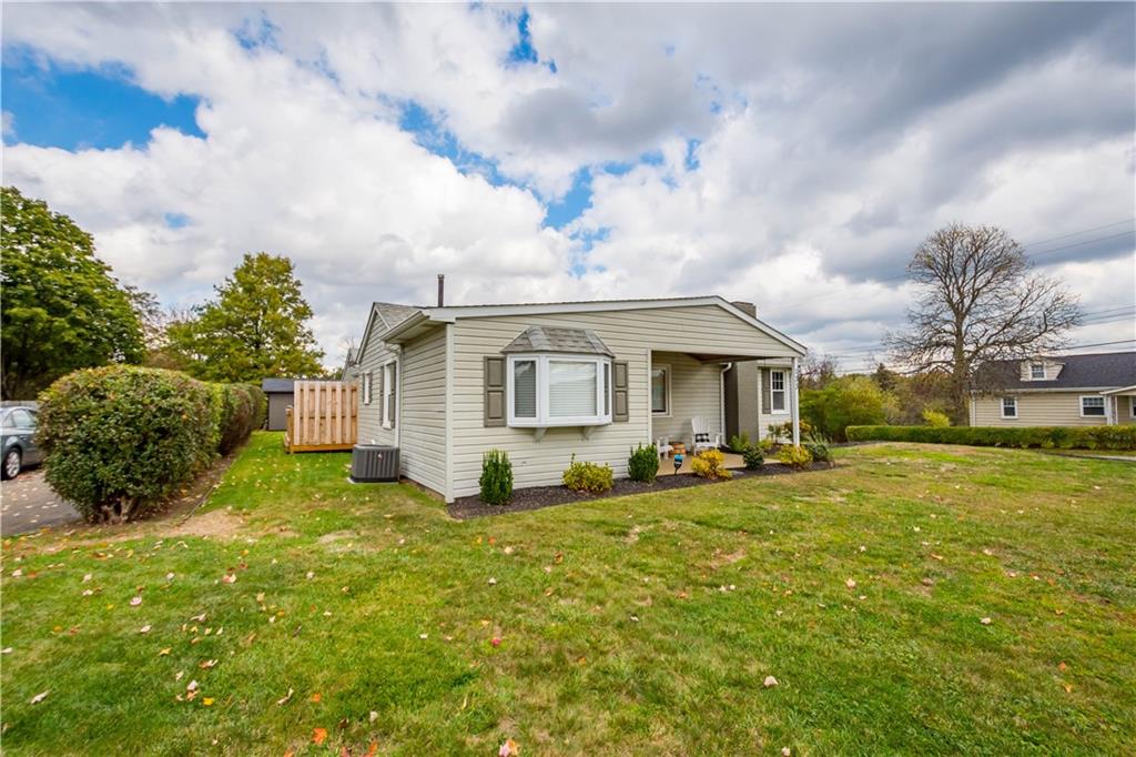 133 Baker Rd Extension Monaca, PA 15061 - Photo 2 of 25 a view of a house with a big yard and large tree
